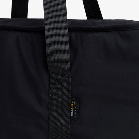 X logo on strap of  Tech Tote Bag - Black 