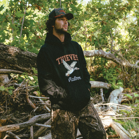 MODEL IN 100 Thieves x Malbon Mallard Hoodie - Black