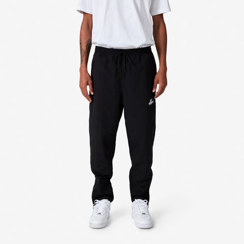 100 Thieves Foundation nylon pants with elastic waistband and 100 Thieves metal aglet tipped drawstrings in the color black