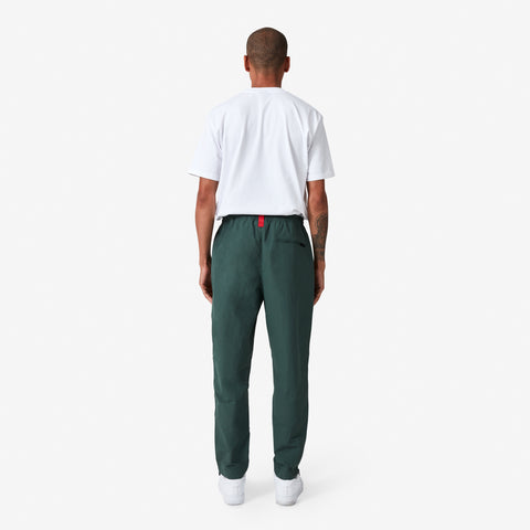 back of 100 Thieves Foundation nylon pants with elastic waistband and 100 Thieves metal aglet tipped drawstrings in the color alpine